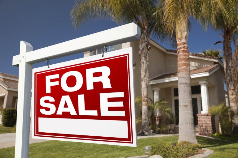 For Sale Real Estate Sign in Front of House by Andy Dean