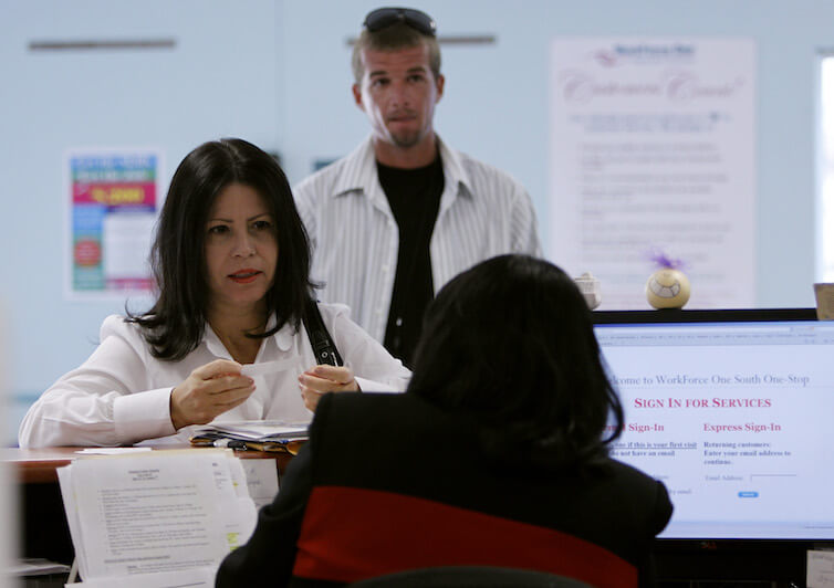A woman signs up for a resume writing workshop. A new working paper finds that the adoption of new technologies such as Microsoft Office and Java leads to increases in pay inequalities between more- and less-educated workers.